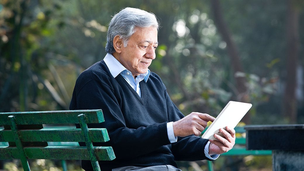 Epicor-Senior-Man-Using-Digital-Tablet-In-Park.jpg