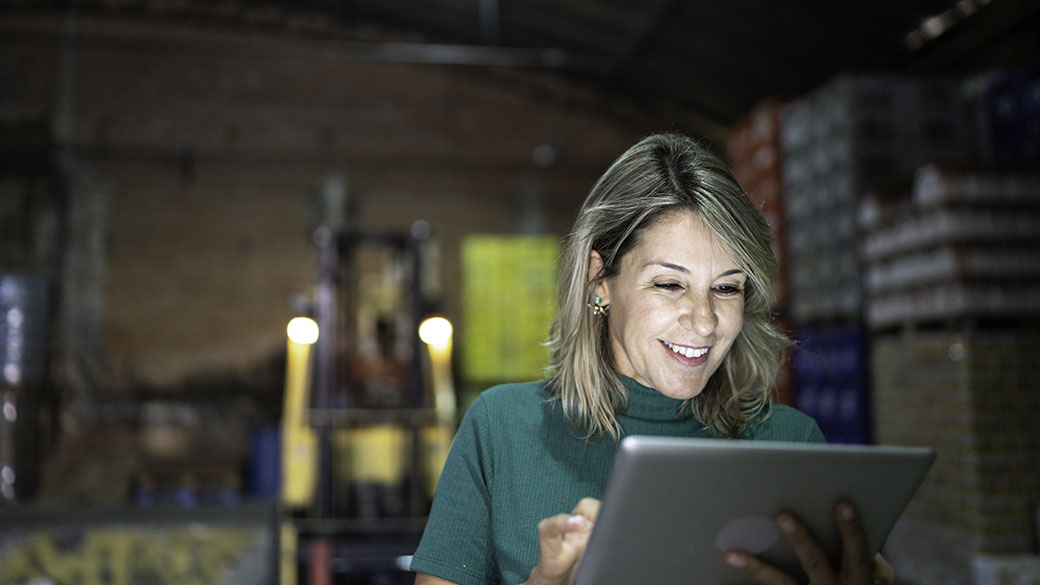 happy-employee-using-digital-tablet-at-warehouse.jpg